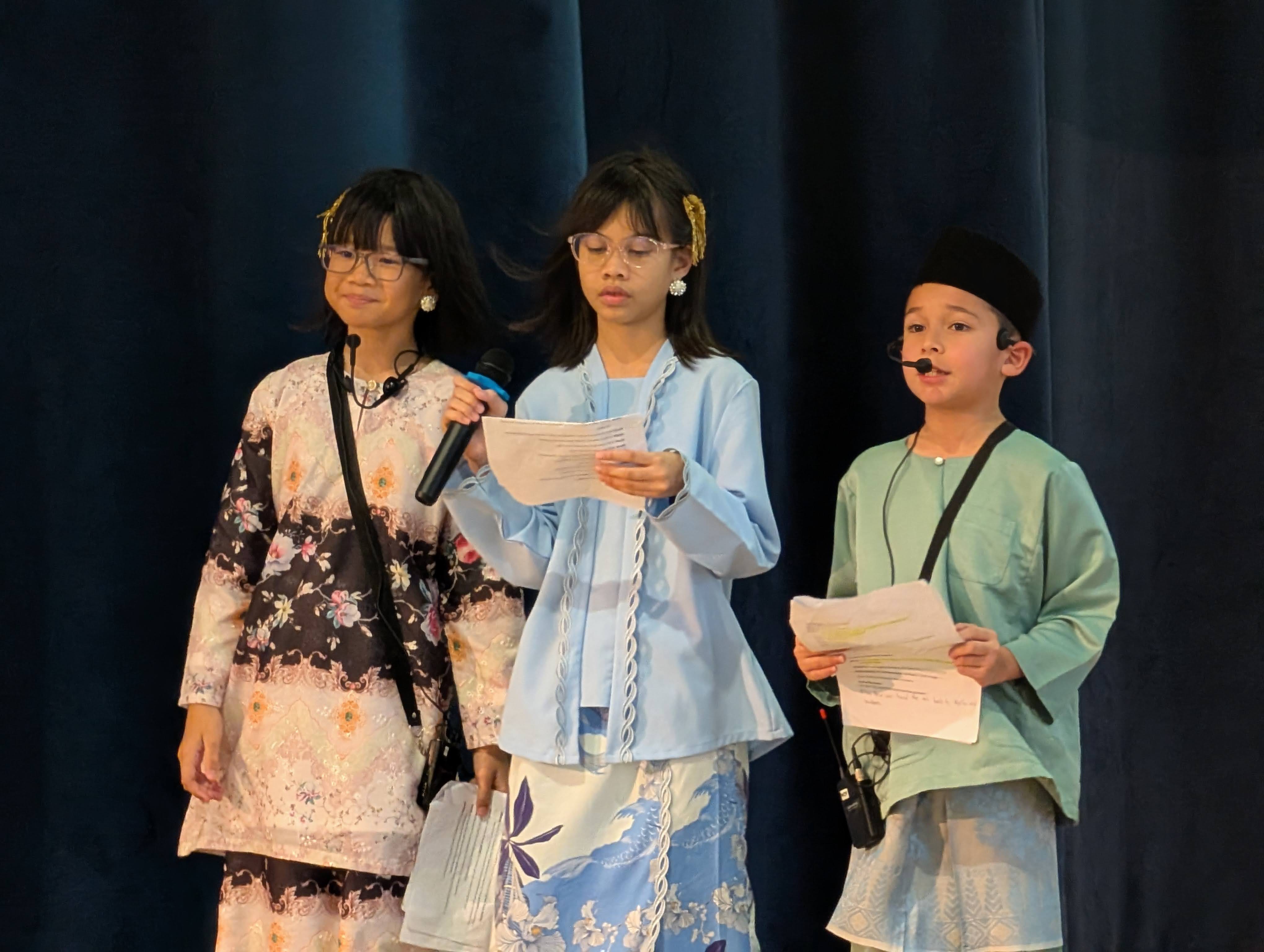 Our junior emcees on stage speaking confidence and doing a wonderful job.